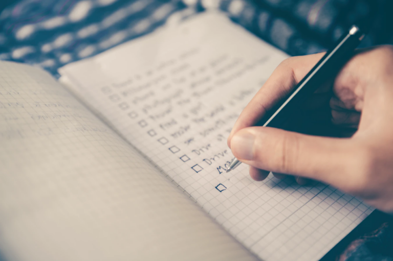 hand writing a checlist with pen