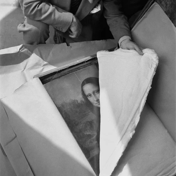 the painting, the mona lisa, is in a box and being unwrapped
